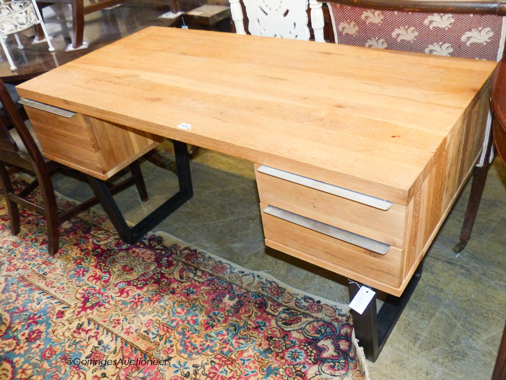 A contemporary black metal and oak kneehole desk, length 135cm, depth 65cm, height 76cm